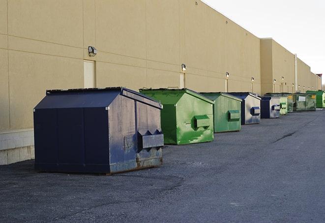 a stack of yellow construction dumpsters on a job site in Bagdad